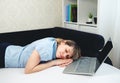 Tired female sleeping. Sleepy girl working remotely in front of laptop