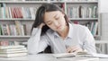 Tired female student falling asleep while studying