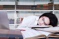 Tired student fell a sleep in a library Royalty Free Stock Photo