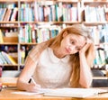 Tired female student n library Royalty Free Stock Photo