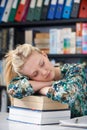 Tired Female Teenage Student Sleeping In Library Royalty Free Stock Photo