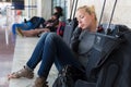 Tired female traveler waiting for departure.