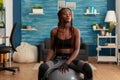 Tired fit black woman after working out in home living room Royalty Free Stock Photo