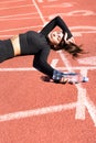 Tired fit woman resting after workout or running, holding a bottle of water, taking a break during training Royalty Free Stock Photo