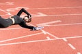 Tired fit woman in sportswear resting after workout or running, holding a bottle of water, taking a break during training Royalty Free Stock Photo