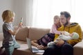 Tired freelancer father with his three kids during quarantine. Home office concept. Online working and household at the same time Royalty Free Stock Photo