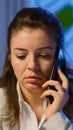 Tired freelancer woman having conversation on phone while working Royalty Free Stock Photo