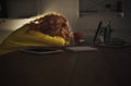 Tired freelancer working on laptop at home until late evening Royalty Free Stock Photo