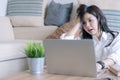 Tired frustrated beautiful young asian teenage feeling stressed holding head with hands at living room