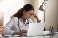 Tired frustrated female doctor feeling stress at workplace