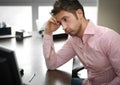 Tired or frustrated office worker looking at computer screen