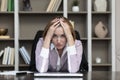 Tired frustrated and overworked business woman sitting in the office and thinking about problems in business Royalty Free Stock Photo