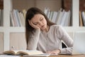 Tired girl student fall asleep studying at workplace