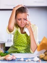 Tired girl signing financial papers at kitchen