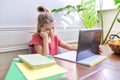 Tired girl student studying at home, child using digital tablet Royalty Free Stock Photo