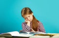 Tired girl in weary state reads book at her desk and experiences dissatisfaction. Lazy student does not want to learn.