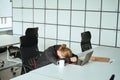 Tired guy dozed off at the laptop at the workplace Royalty Free Stock Photo