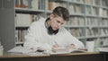Tired guy falls asleep while preparing for examination at school library Royalty Free Stock Photo