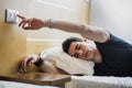 Tired Guy Switching off Light While Lying on Bed Royalty Free Stock Photo