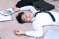 Tired handsome young man sleeping on the browe bed after overworked while come back his condominium. Exhausted businessman falling Royalty Free Stock Photo