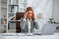 Tired, having headache. Woman in business formal clothes is working in office Royalty Free Stock Photo