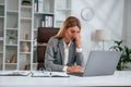 Tired, having headache. Woman in business formal clothes is working in office Royalty Free Stock Photo