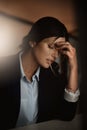 Tired, headache and business woman in pain at night for career migraine, burnout and mental health risk or depression Royalty Free Stock Photo