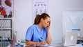 Tired healthcare medical assistant working in hospital researching Royalty Free Stock Photo