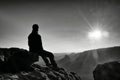 Tired hiker take a rest in nature. Mountain summit above forest in valley. Traveling in European natural parks.