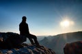 Tired hiker take a rest in nature. Mountain summit above forest in valley. Traveling in European natural parks.