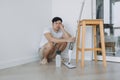 Tired househusband man sit on the floor after mopping the room. Royalty Free Stock Photo