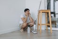 Tired househusband man sit on the floor after mopping the room. Royalty Free Stock Photo