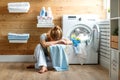 Tired housewife woman in stress sleeps in laundry room with wash