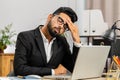 Tired Indian business man suffering from headache problem tension, migraine, stress at home office Royalty Free Stock Photo