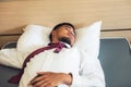 Tired Indian businessman sleep on hotel bed Royalty Free Stock Photo