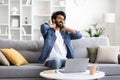 Tired Indian Male Massaging Inflamed Neck After Working On Laptop At Home Royalty Free Stock Photo