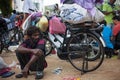 Tired indian old man squats outdor relax on the street