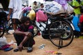 Tired indian old man squats outdor relax on the street