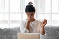 Tired Indian woman massaging nose bridge, feeling eye strain