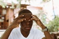 tired interracial dark skin man in eyeglasses touching and rubbing his eyes, feeling pain. Vision problem Royalty Free Stock Photo