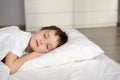 Tired kid sleeping in bed, happy bedtime in white bedroom