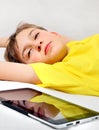 Tired Kid with a Tablet Royalty Free Stock Photo