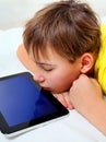 Tired Kid with Tablet Royalty Free Stock Photo