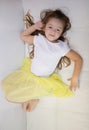 Tired lazy little girl lying on sofa at home. Sleepy kid resting relaxing on couch Royalty Free Stock Photo