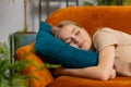 Tired lazy woman enjoy relaxing on home sofa resting napping after hard working day, closed her eyes Royalty Free Stock Photo