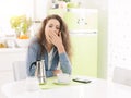 Tired woman having breakfast at home Royalty Free Stock Photo