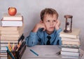 Tired of the lessons of the European boy at the table with books Royalty Free Stock Photo