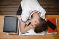 Tired of lessons, a teenager at home for textbooks sleeps at the table. The view from the top Royalty Free Stock Photo