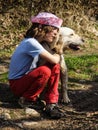 Tired little girl hugs her dog. Royalty Free Stock Photo