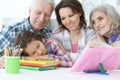 Tired little girl sleeping after doing homework while mother and Royalty Free Stock Photo